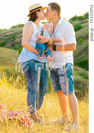 Happy family with little baby spending time together at sunset Happy family with little baby spending time together at sunset 55335052