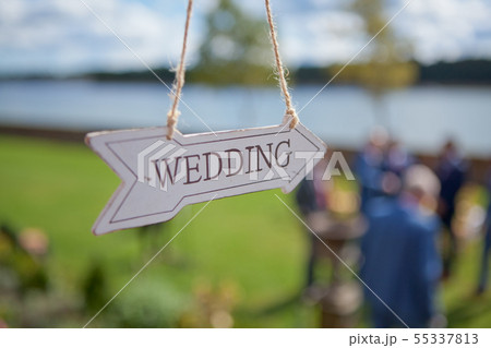 Wooden direction with wedding text is hanging near Wooden direction with wedding text is hanging near 55337813