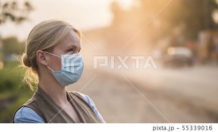 A woman in a gauze bandage is on a dusty road. Environment and ecology concept A woman in a gauze bandage is on a dusty road. Environment and ecology concept 55339016