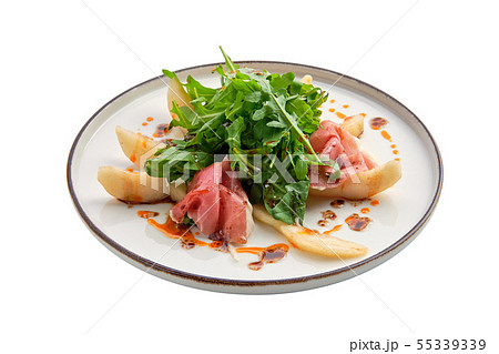 Salad with jamon, pear and arugula isolated on Salad with jamon, pear and arugula isolated on 55339339