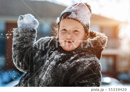Child with shovel playing outdoors in winter Child with shovel playing outdoors in winter 55339420