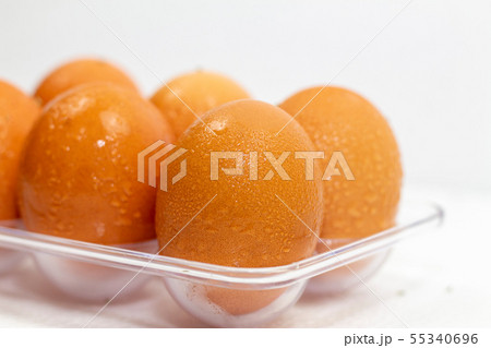 Close up of wet clean chicken eggs in a plastic Close up of wet clean chicken eggs in a plastic 55340696