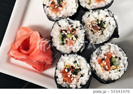 Set of rolls with red fish and ginger. Table setting. Black background. 55341470