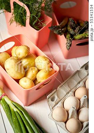 Fresh asparagus potatoes and eggs on white  kitchen table 55341534