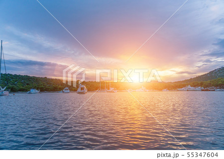 calm bay at evening with moored yachts 55347604