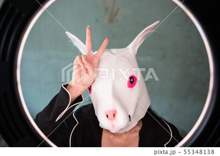 Girl with rabbit mask with v sign 55348138