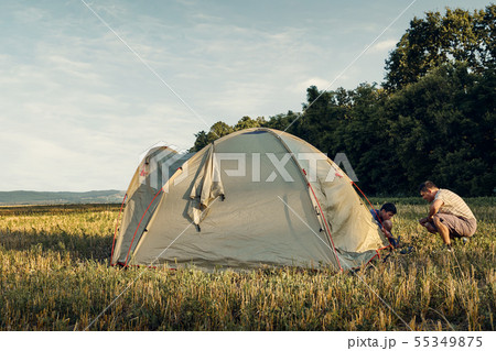 Family set up tent camp at sunset, beautiful Family set up tent camp at sunset, beautiful 55349875