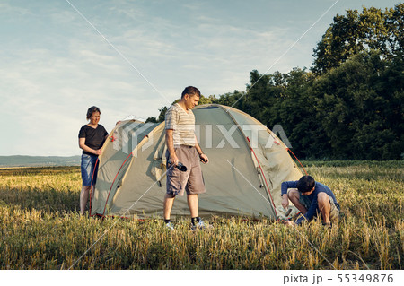 Family set up tent camp at sunset, beautiful 55349876