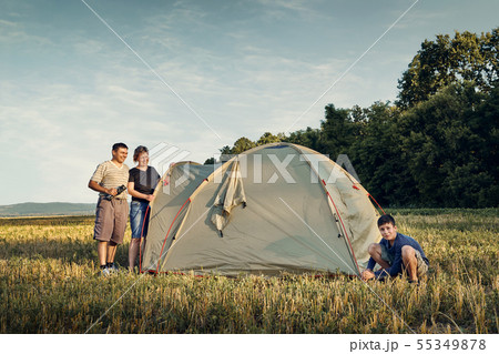 Family set up tent camp at sunset, beautiful 55349878