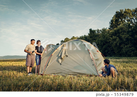 Family set up tent camp at sunset, beautiful 55349879