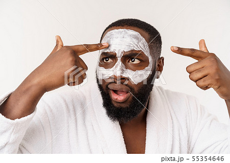A young man with paper mask on face looking shocked with an open mouth, isolated on a white A young man with paper mask on face looking shocked with an open mouth, isolated on a white 55354646