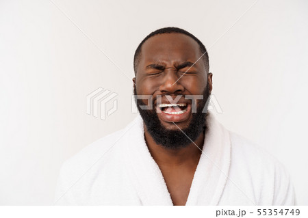 Young african american man wearing bathrobe over isolated white background thinking looking tired Young african american man wearing bathrobe over isolated white background thinking looking tired 55354749