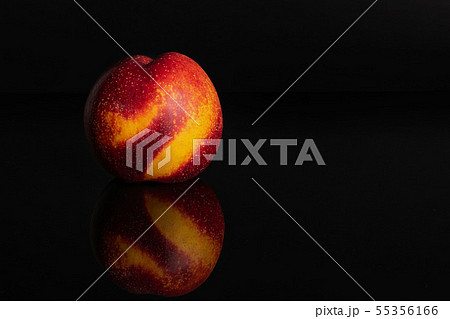 Fresh red nectarine isolated on black glass Fresh red nectarine isolated on black glass 55356166