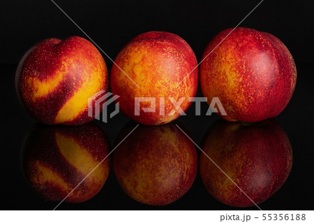 Fresh red nectarine isolated on black glass 55356188
