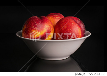 Fresh red nectarine isolated on black glass 55356189