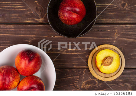 Fresh red nectarine on brown wood 55356193