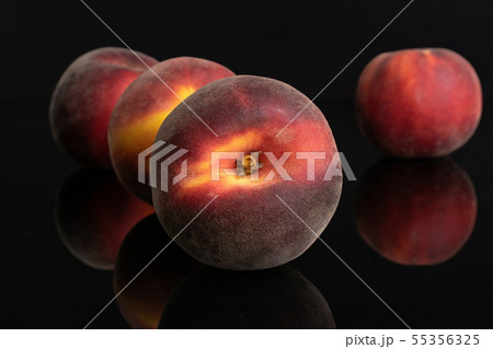 Fresh red peach isolated on black glass 55356325