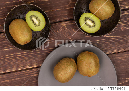 Fresh green kiwi on brown wood Fresh green kiwi on brown wood 55356401