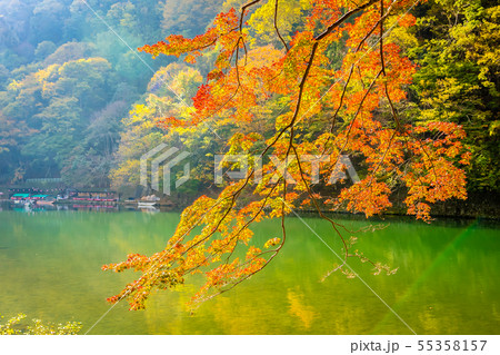 Beautiful Arashiyama river with maple leaf tree and boat around lake Beautiful Arashiyama river with maple leaf tree and boat around lake 55358157