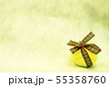 Tennis ball with Christmas ribbon on yellow backgr 55358760