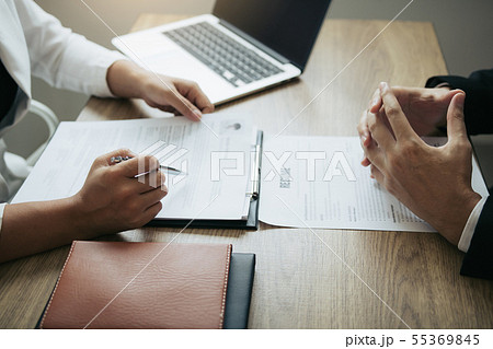 Female employee are describing the employment Female employee are describing the employment 55369845