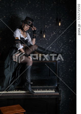 Sexy girl steampunk sitting on piano indoors 55373550