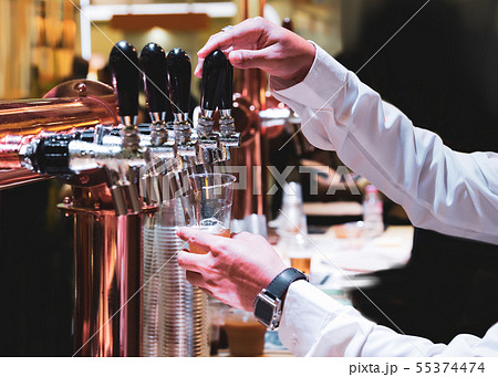 Bartender pouring draft beer in the bar, Barman Bartender pouring draft beer in the bar, Barman 55374474