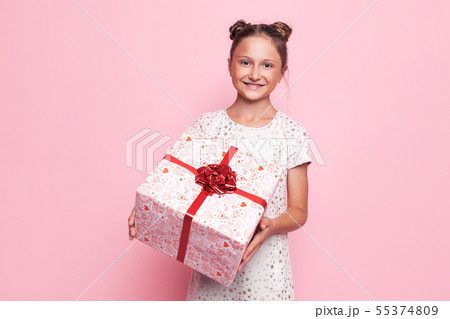 Portrait of a happy teenage girl with a gift box Portrait of a happy teenage girl with a gift box 55374809