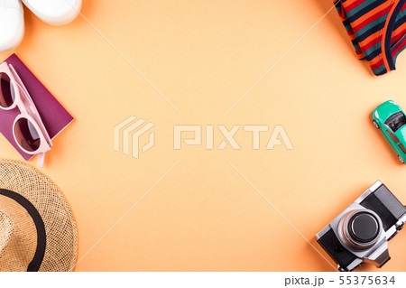 Travel items flat lay on orange with camera 55375634
