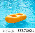 Yellow rubber ring floating in the pool 55378921