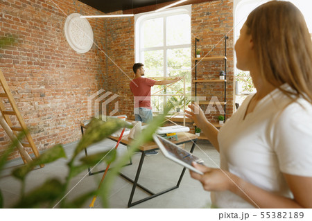 Young couple doing apartment repair together themselves Young couple doing apartment repair together themselves 55382189