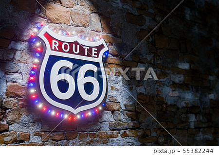 Route 66 light emblem banner on old grunge brick Route 66 light emblem banner on old grunge brick 55382244