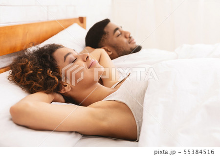 Loving couple sleeping in bed and hugging Loving couple sleeping in bed and hugging 55384516