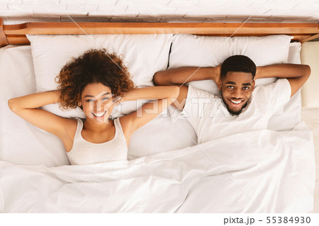 Happy married black couple resting in bed Happy married black couple resting in bed 55384930