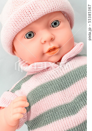 Cute baby doll for girl in knitted dress close up Cute baby doll for girl in knitted dress close up 55385367