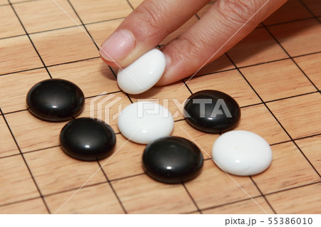hand playing go a strategicboard  game 55386010