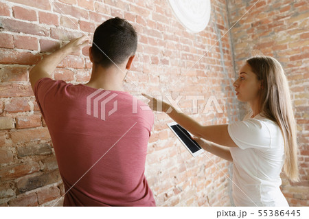 Young couple doing apartment repair together themselves Young couple doing apartment repair together themselves 55386445