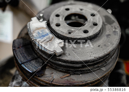 old brake pads on the brake disc with a shallow depth of field old brake pads on the brake disc with a shallow depth of field 55386816