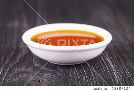 The sea buckthorn oil in the white small Cup on The sea buckthorn oil in the white small Cup on 55387124