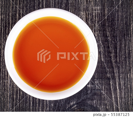 The sea buckthorn oil in the white small Cup on The sea buckthorn oil in the white small Cup on 55387125