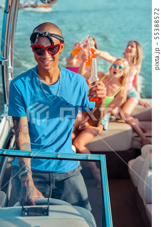 Young African American man in heart-shaped sunglasses outdoors 55388572