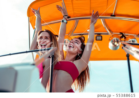 Young female friends enjoying life to the full Young female friends enjoying life to the full 55388615