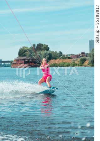 Fit Caucasian attractive wakeboarder in a pink outfit looking straight ahead 55388817