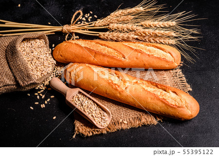 Fresh fragrant bread with grains and cones  55395122