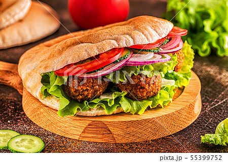 Falafel and fresh vegetables in pita bread. Falafel and fresh vegetables in pita bread. 55399752