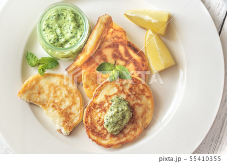Portion of ricotta fritters with mint sauce Portion of ricotta fritters with mint sauce 55410355