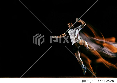 Young handball player against dark studio background in mixed light Young handball player against dark studio background in mixed light 55410520