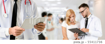 Doctor working in hospital with other doctors. 55411736