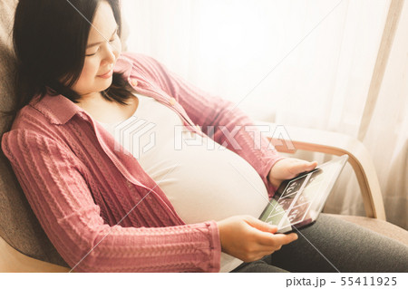 Happy pregnant woman and expecting baby at home. 55411925