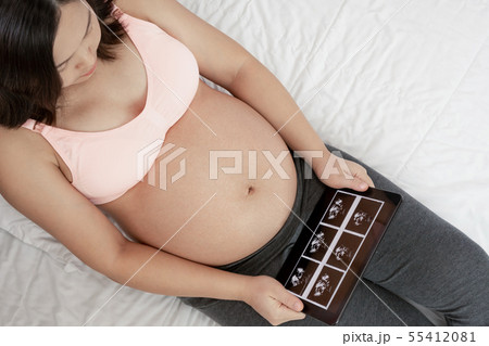 Happy pregnant woman and expecting baby at home. 55412081